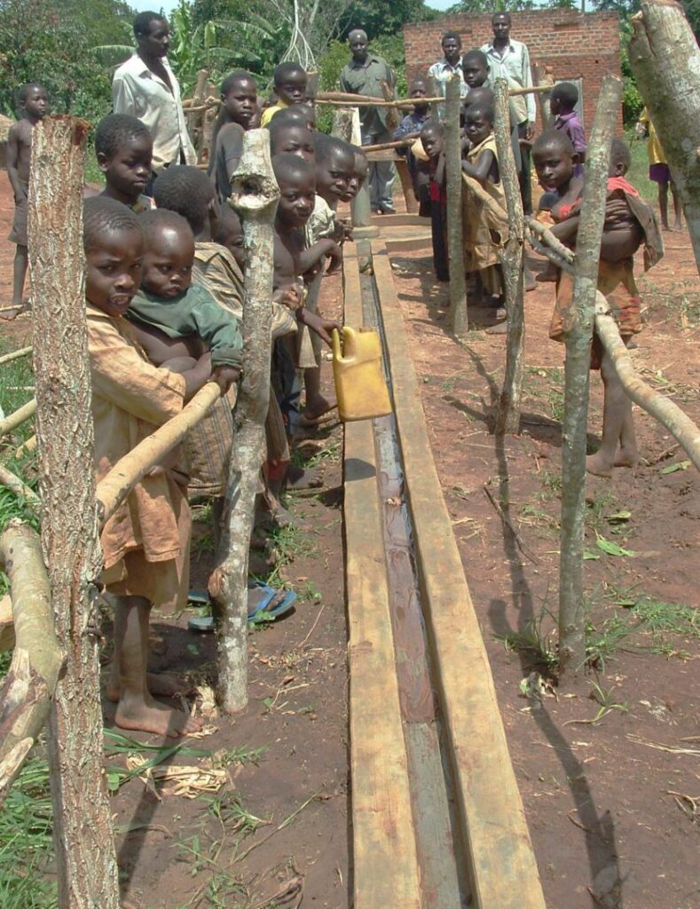 Uganda-village-at-borehole-832x1080